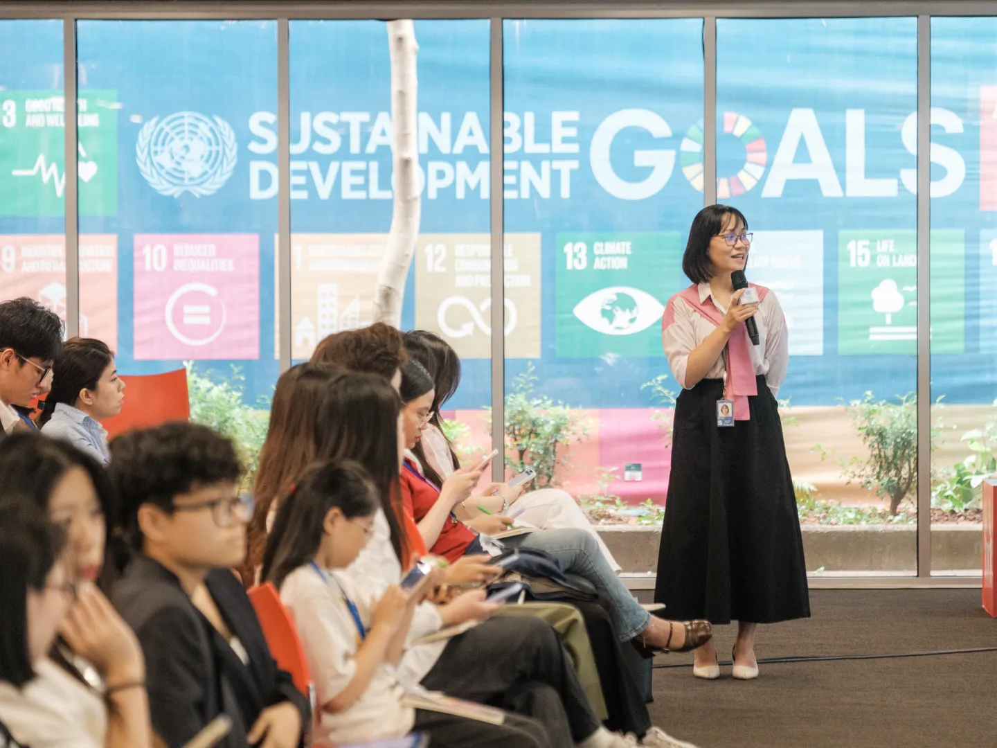 Facilitating the dialogue, Nguyen Ngoc Duyen, ILO National Project Officer, creates space for youth to share their views on what defines a decent job, the importance of environmental responsibility, and their role in shaping the future world of work.