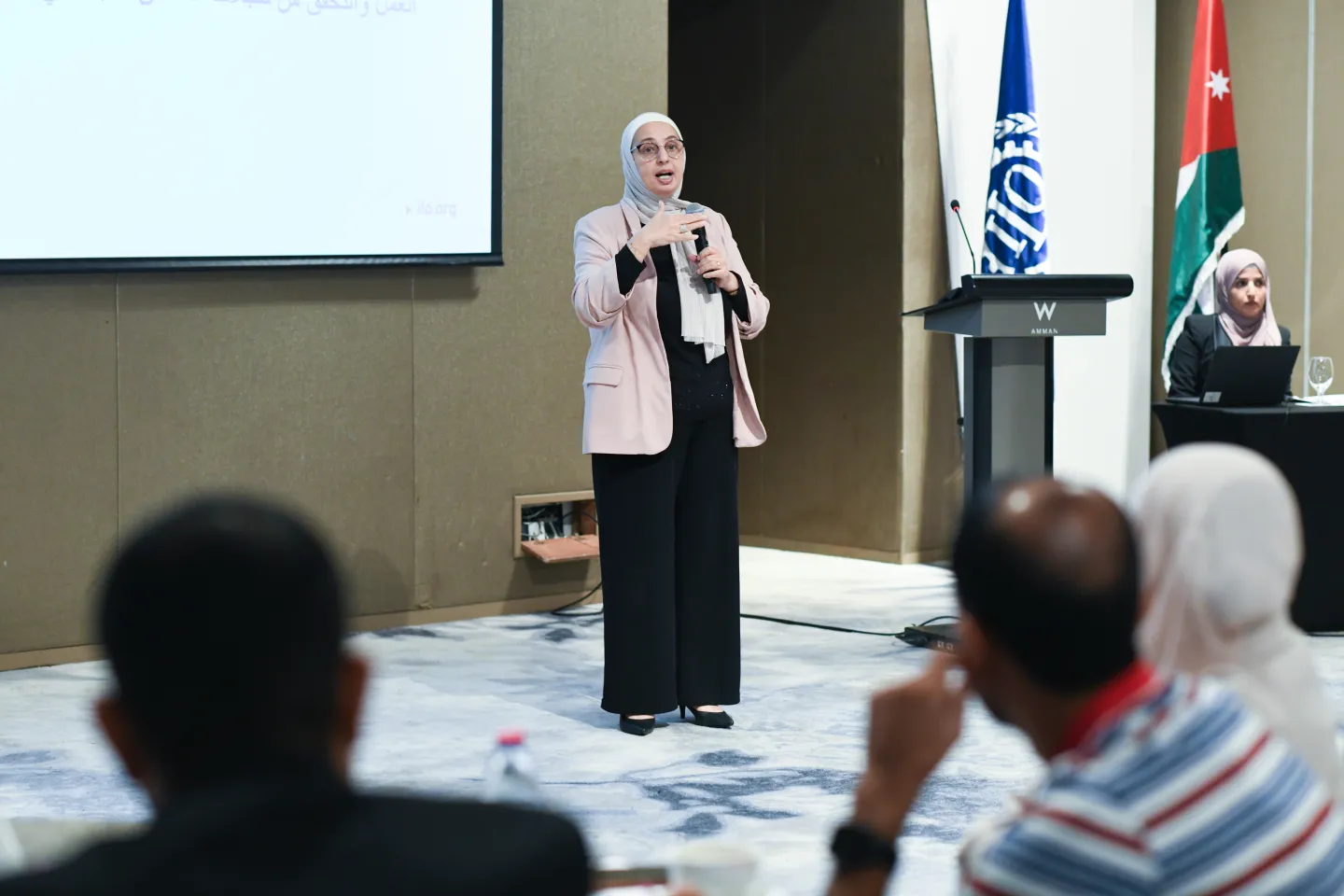 Maha Kattaa, Regional Chief Technical Adviser for the PROSPECTS Programme, presenting during the National Workshop on Public Works, Jordan, 09/2025. © Nadia Bseiso/ILO”.