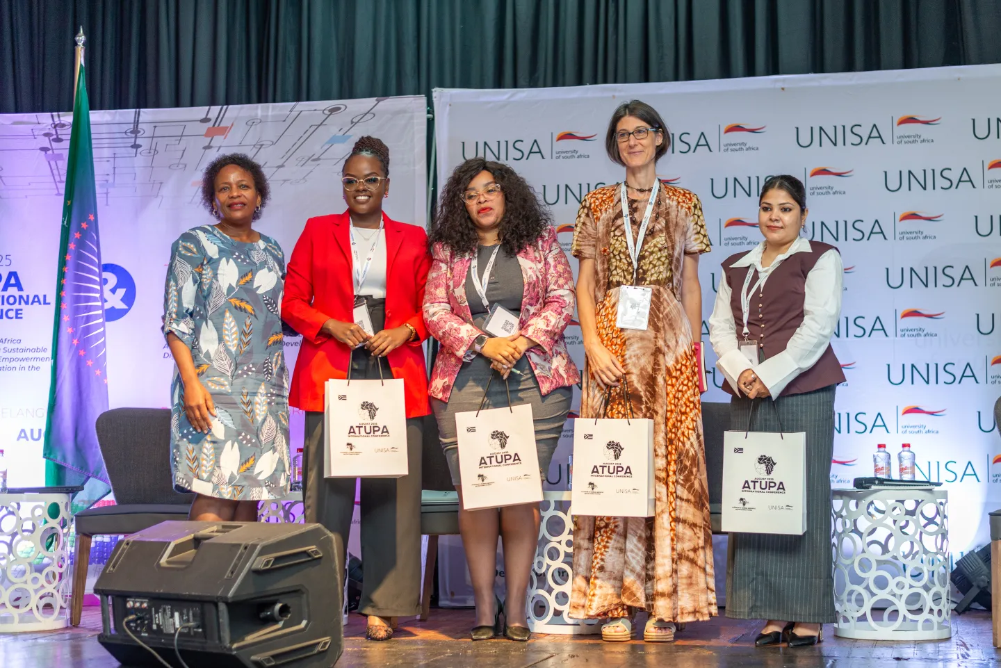 5 women standing on the stage of 2025 ATUPA Conference, Durban, South Africa, August 2025
