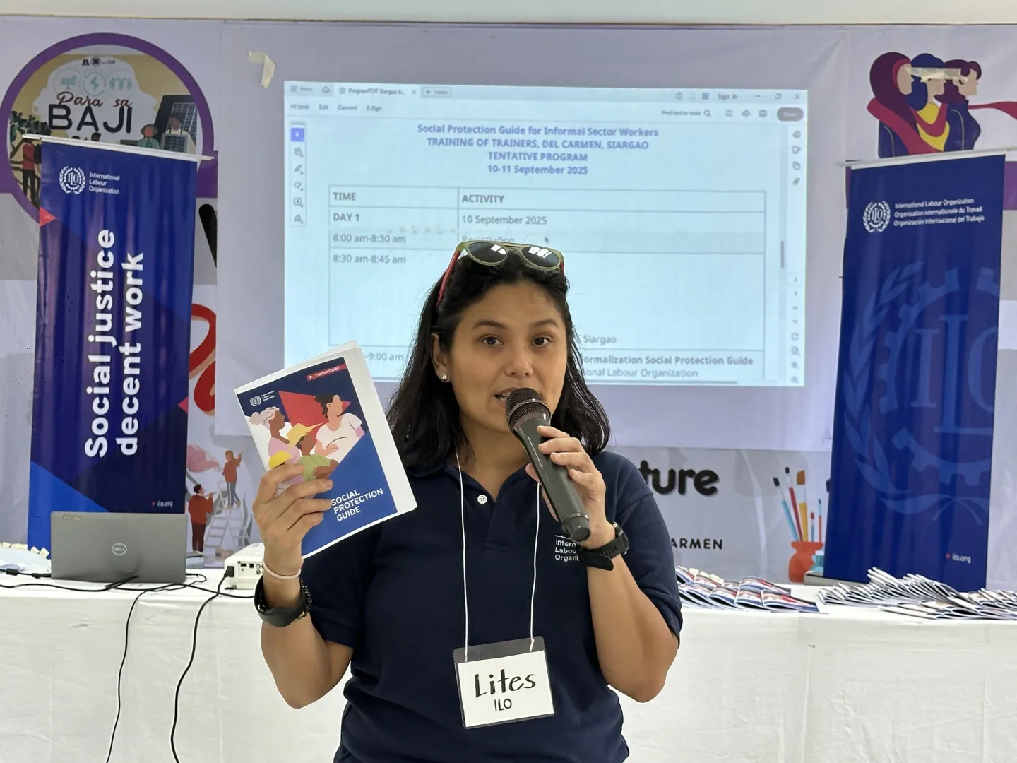 an ILO female official holds the Social Protection Guide