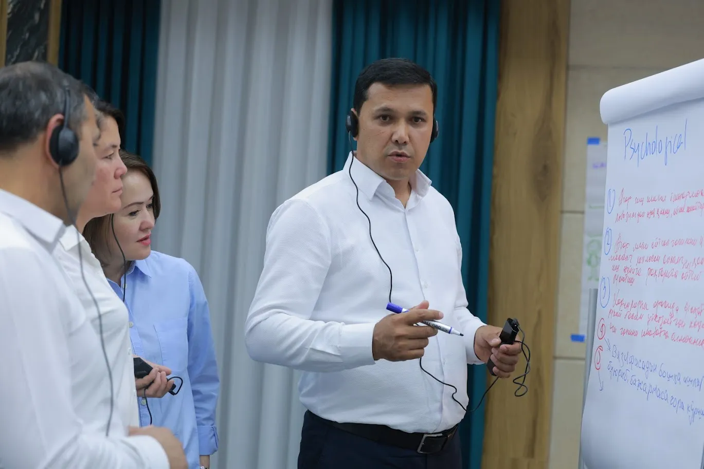 People standing in front of a flipchart