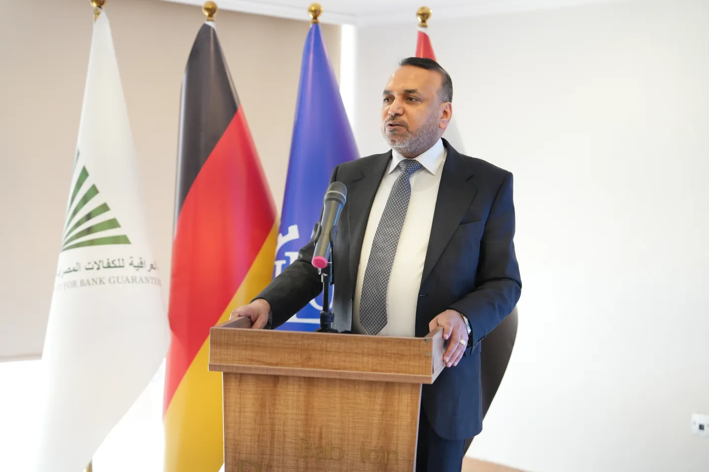 Ahmed Al-Assady, Minister of Labour and Social Affairs of Iraq, speaking at a podium