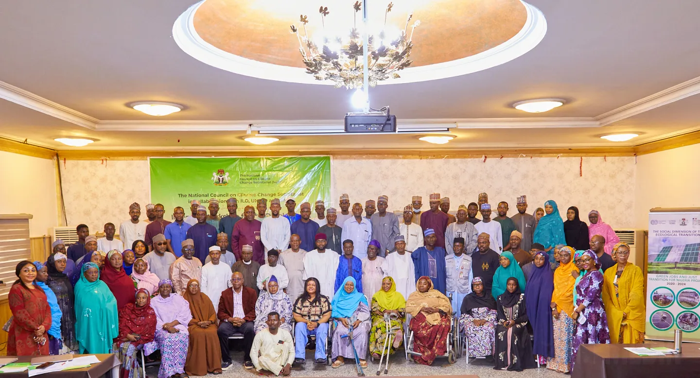 A formal group photograph capturing attendees of the Climate Action Kano workshop