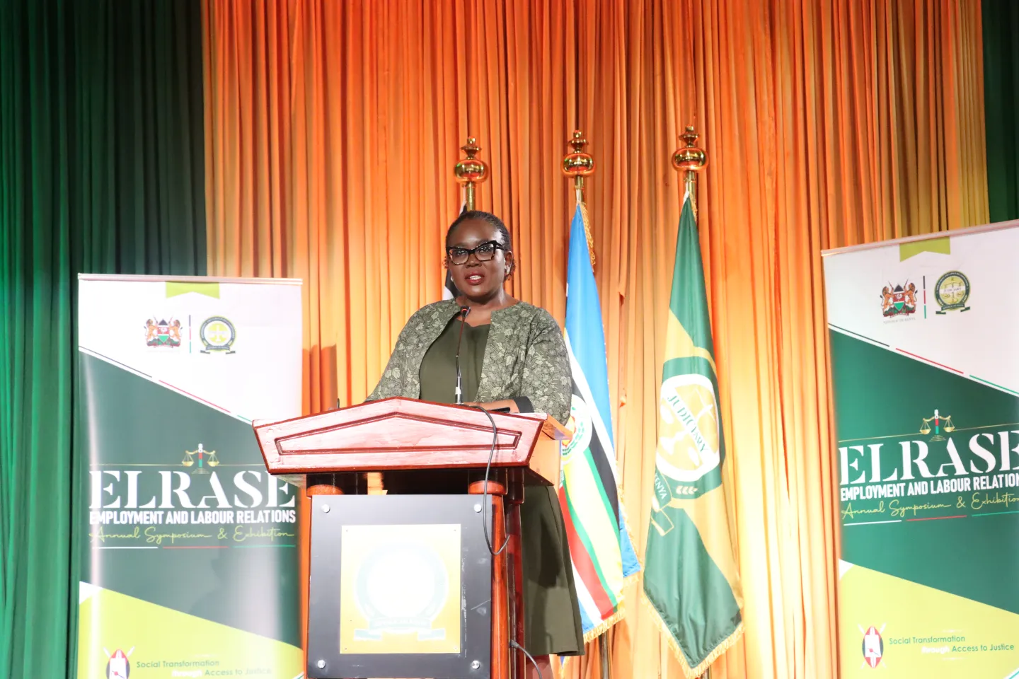 ILO Director Country Office Dar Es Salaam Caroline Khamati Mugalla, speaks at the podium during the opening ceremony of the Employment and Labour Relations Annual Symposium and Exhibition III in Nairobi.