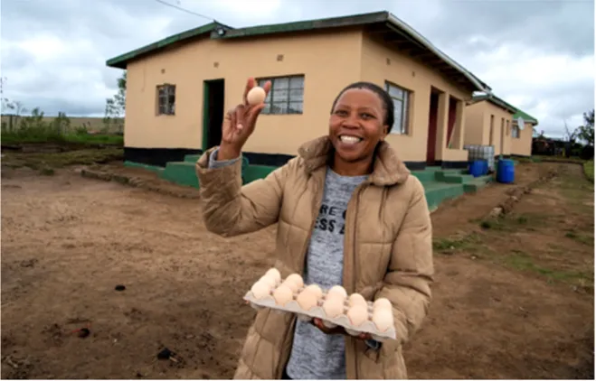 South African woman showing eggs from her business