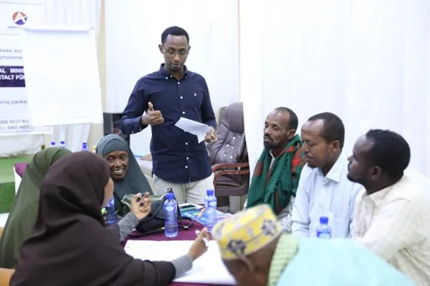 Abdiftah Salad Omar-one of four certified SIYB trainers- explaining a point to a group of trainees during one of the group discussions