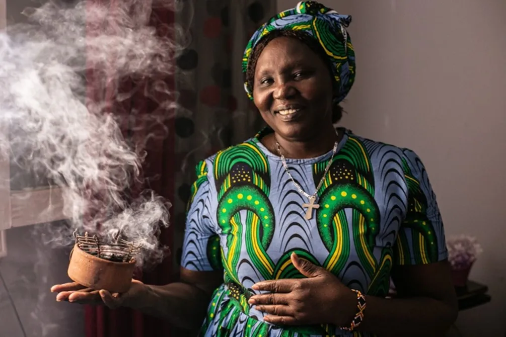 Sudanese women showing her incense sticks she sells in Egypt