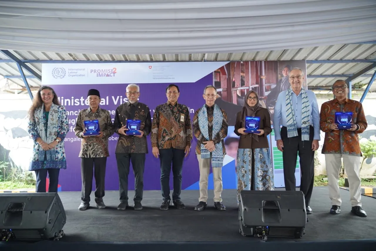 Eight people standing on stage