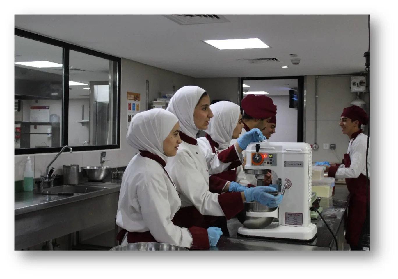 A group of female students working with a mixer during a course in Amman, Jordan