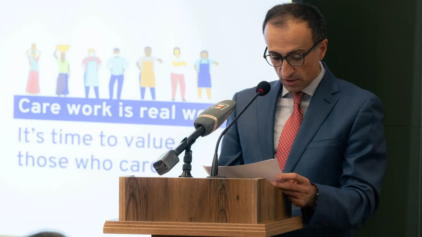 A man standing at a podium with a microphone
