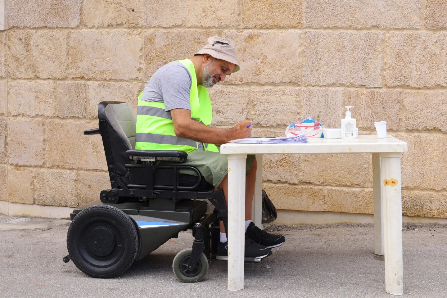 Raymond Khoury working while on his wheelchair