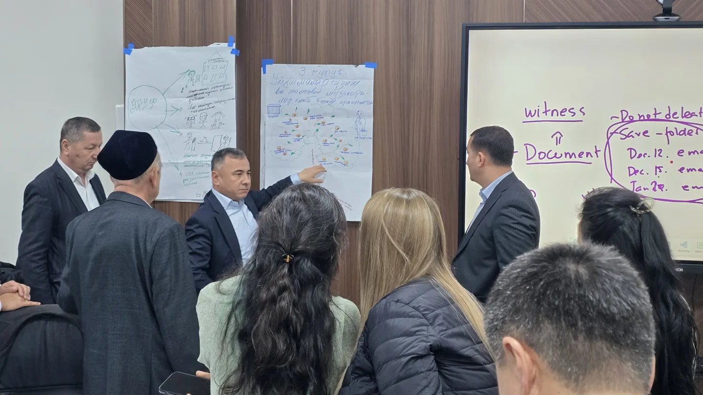 People standing in front of a flipchart