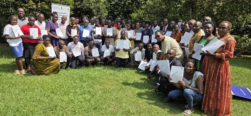 Participants to the cooperative training take a group photo showing their certificates