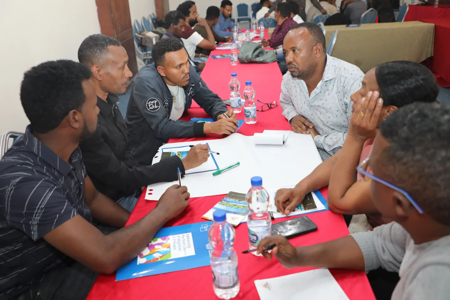 Trainees working in groups around a table