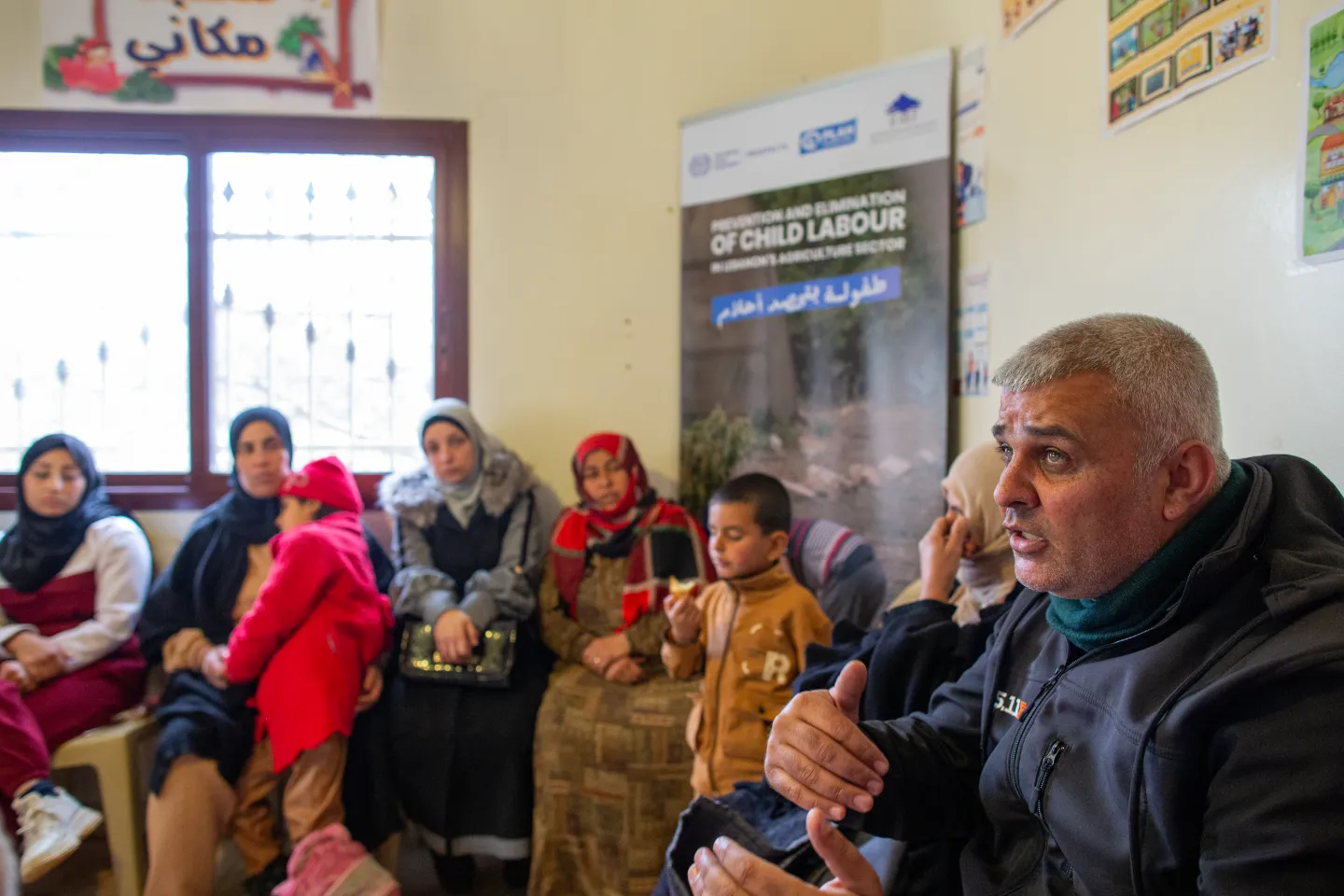 Syrian agricultural workers and their children attend an ILO-led discussion on their needs at a local centre, Bekaa Valley, 15 December 2025. 