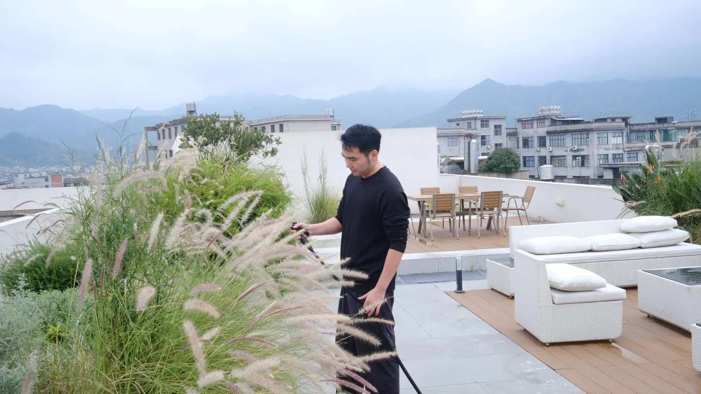 Ying Changbin waters the rooftop garden of his kitchenware manufacturing business. 