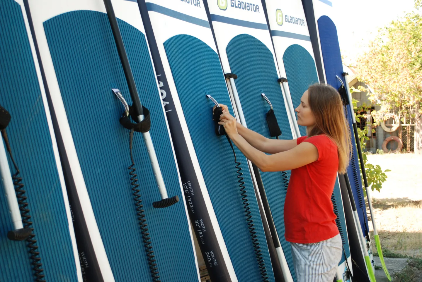 Ukrainian women checking up the Stand Up Paddle boards before letting the clients use them