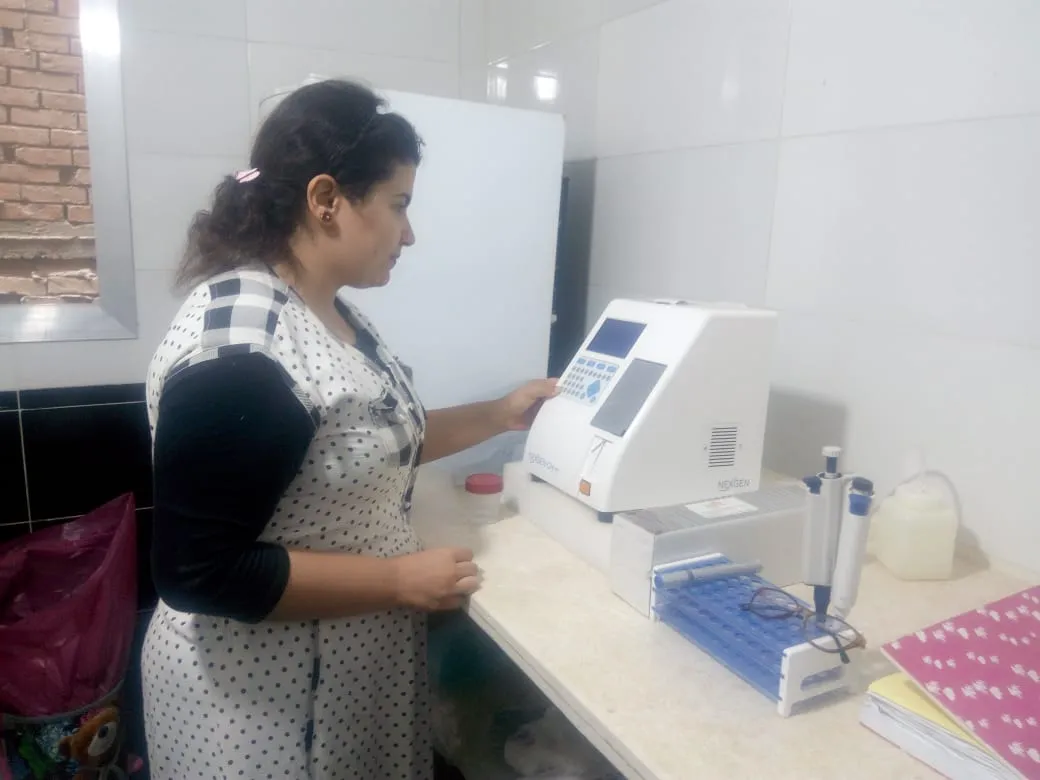 Egyptian woman in her care lab, recording data