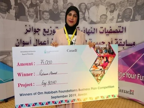 Woman from Egypt receiving an award for her fashion business