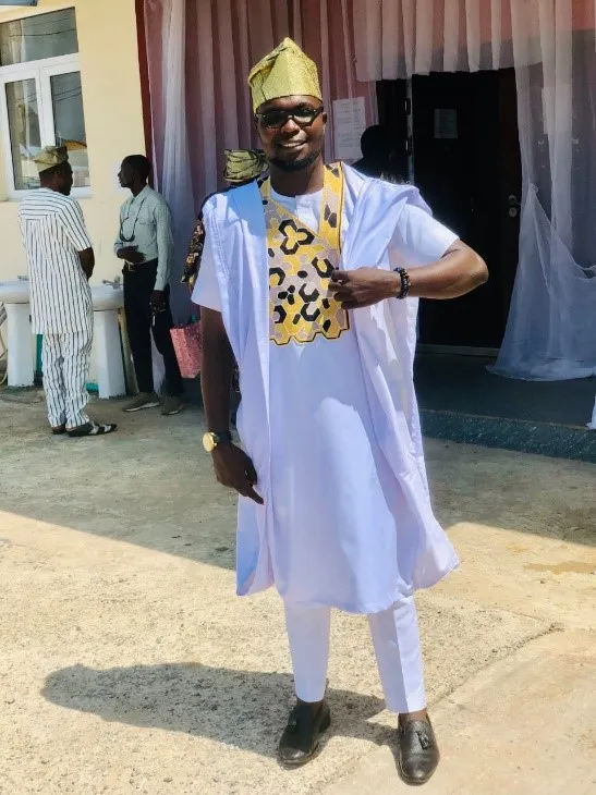 Nigerian entrepreneur showing cloth designed and sold by his fashion business