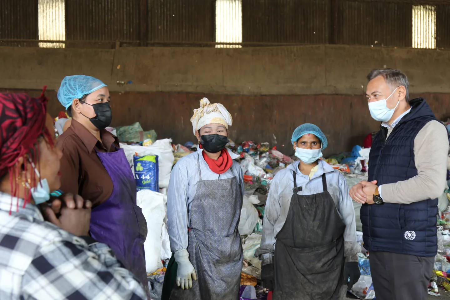 Mr. Numan &Ouml;zcan engaging with waste segregators to hear their workplace concerns.