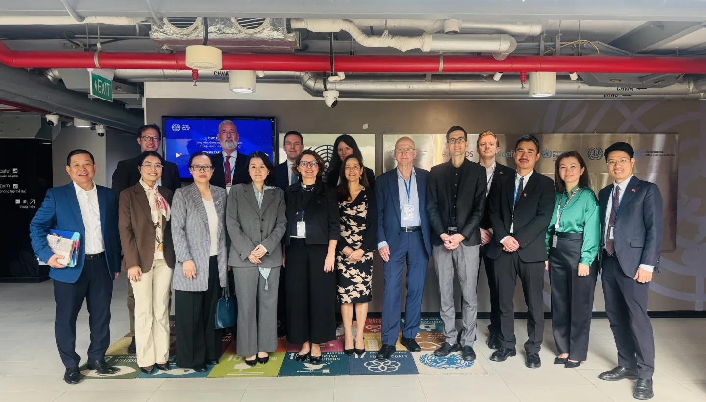 Members of the Swiss tripartite delegation stand together for a group photo at the UN House after a meeting with the ILO Country Office for Viet Nam.