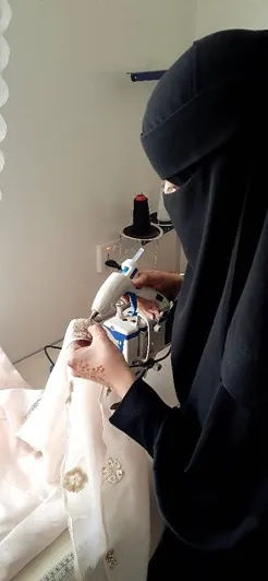 Yemeni woman tailoring in her  fashion business