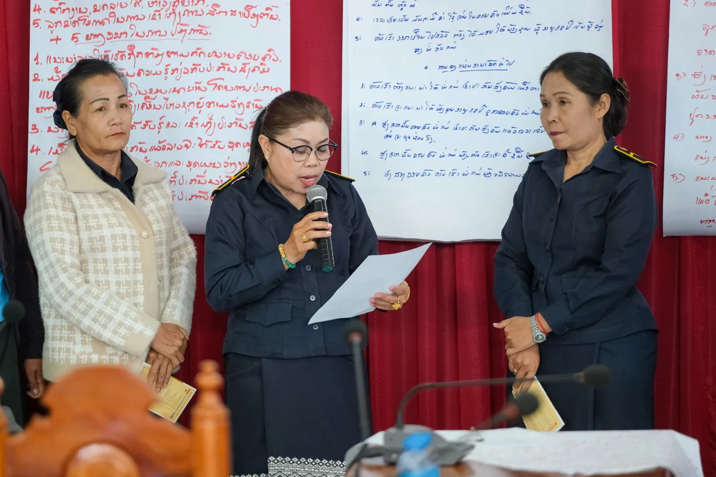 A group of three ladies. One is speaking. 