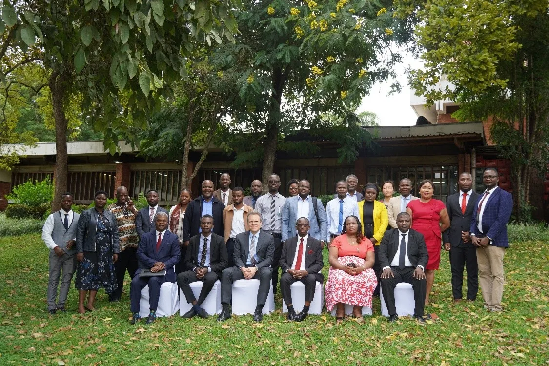 Group photo of participants outdoors.