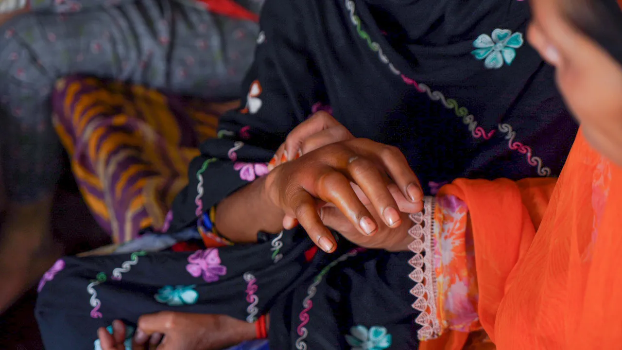 A close-up of a cotton picker’s hand that has been bitten by an insect and is red and swollen.