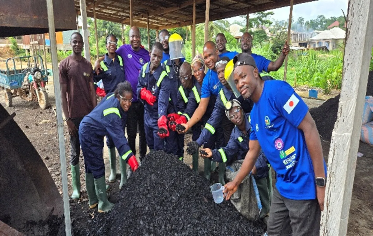 Cocoa farmers and project participants in Ghana display biochar produced from cocoa pod husks as part of a climate-smart initiative to strengthen livelihoods and help prevent child labour.