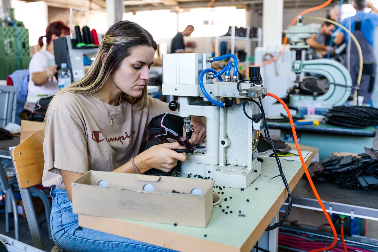 Young woman working with a sewing machine
