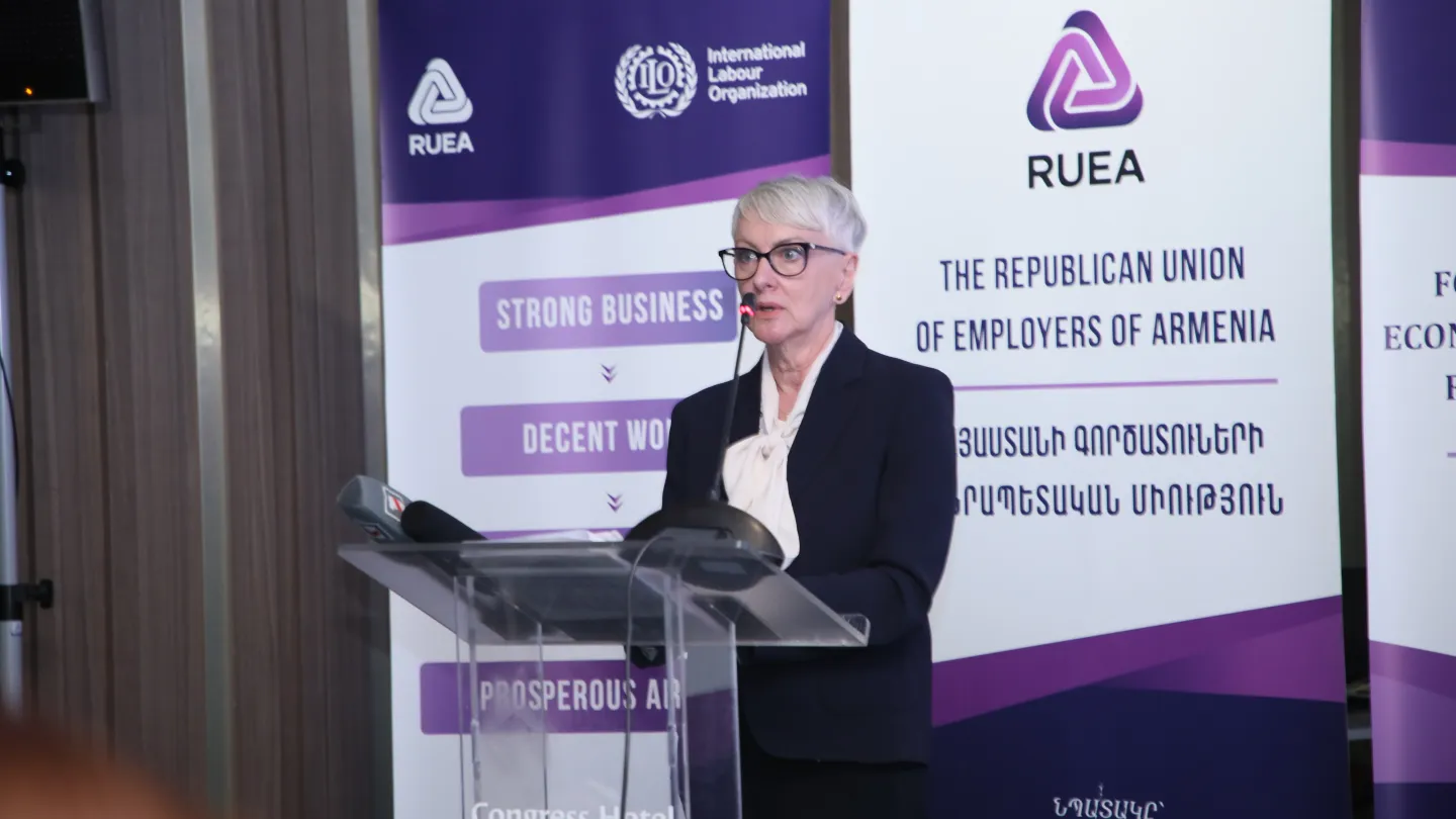 A woman standing behind a podium