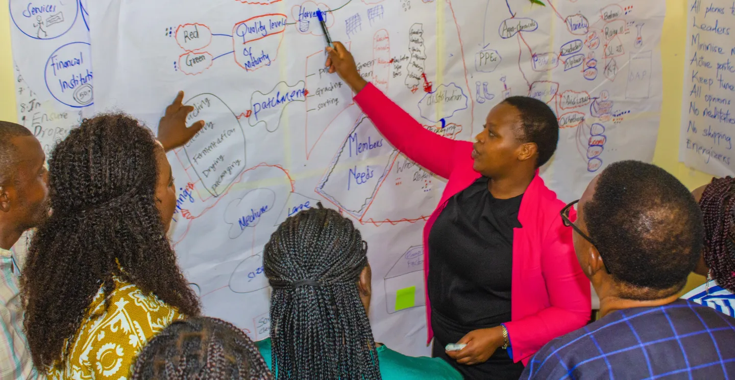 Participant making a group presentation during the COOP ToT training.