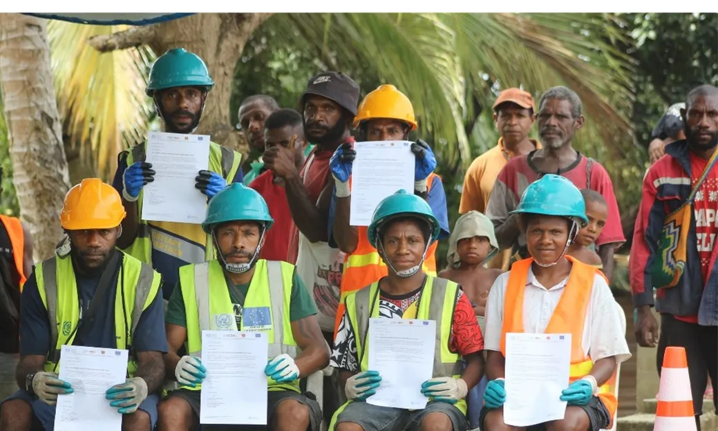 Group of workers (men) holding their certificates
