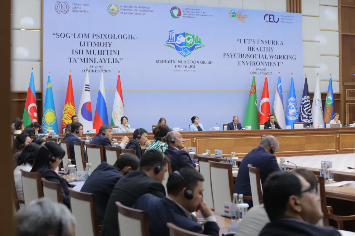 Panellists and audience sitting in conference hall