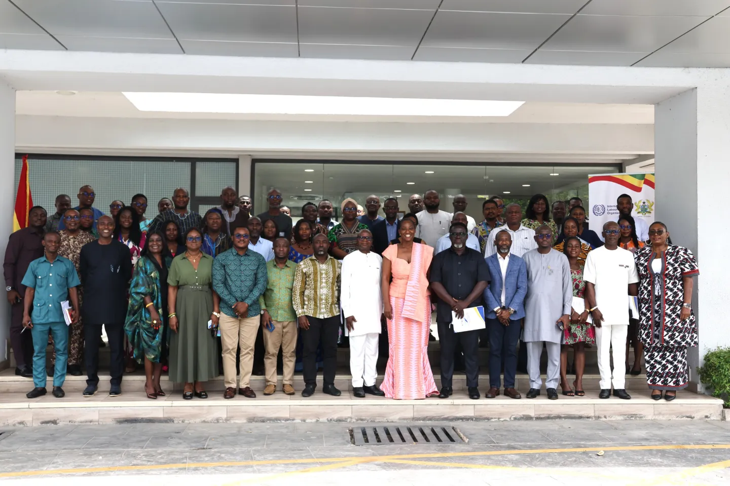 A large group of participants pose outside a building after the launch of Ghana’s Decent Work Country Programme III.
