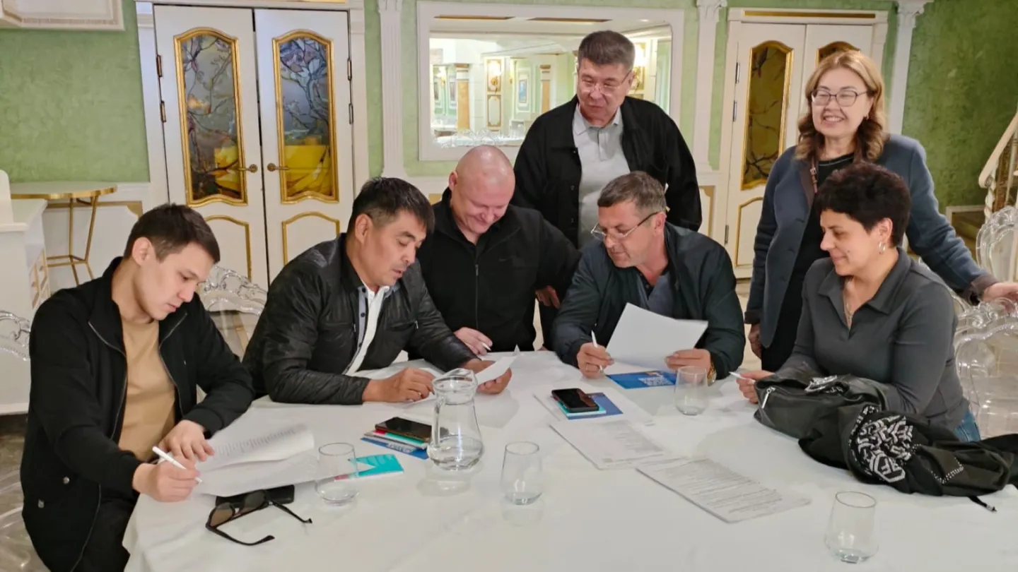 Group of seven people gathered around a table