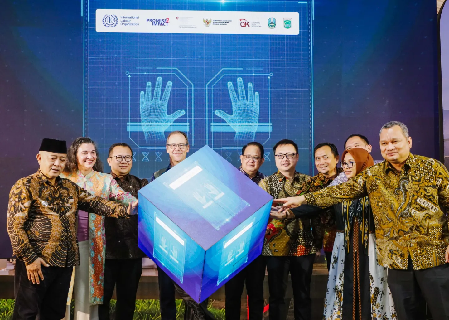 Government officials and development partners stand on stage and jointly launch an ERP system for East Java’s dairy sector, symbolizing collaboration to advance digitalization and financial inclusion for dairy farmers.
