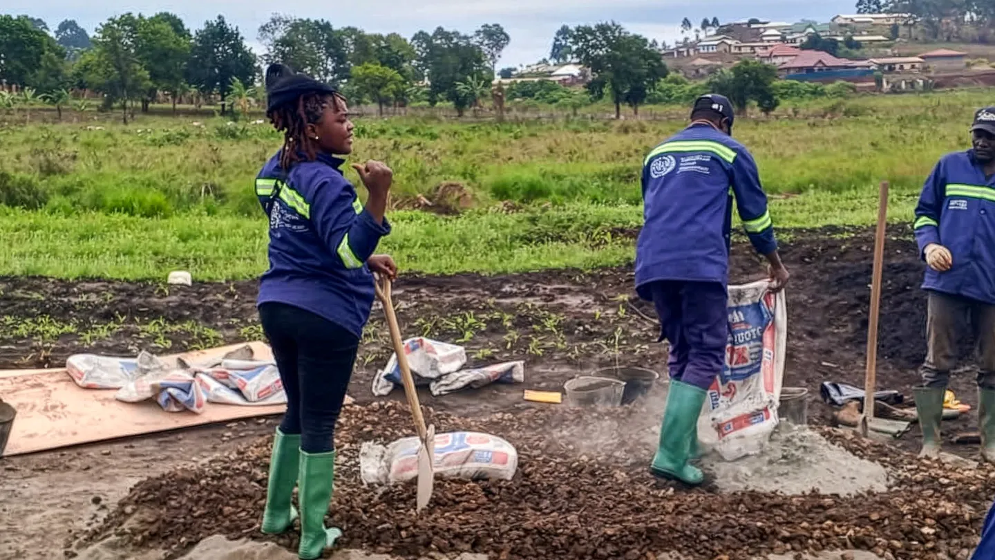 Ngeibi Reina, 26, from Nkambe, mixes mortar at a road rehabilitation worksite in Nkambe, Cameroon.