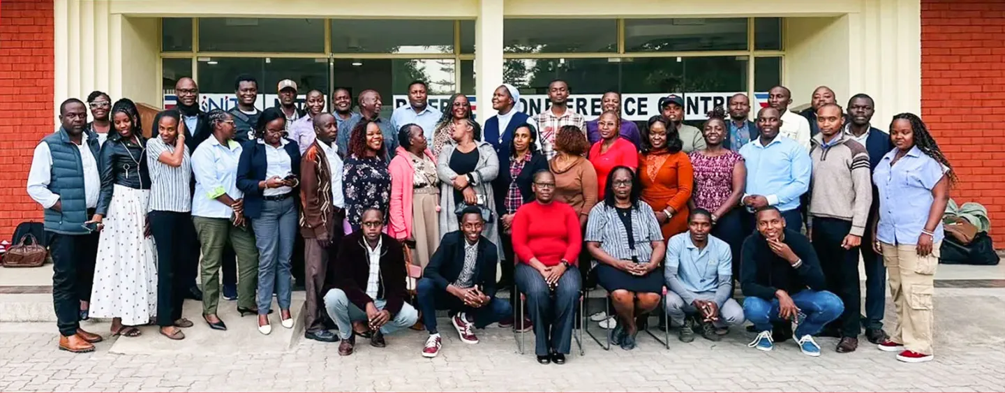 A large group of stakeholders poses for a photo outside a conference facility in Kenya after a forum to validate new occupational curricula for the tourism and fodder sectors.