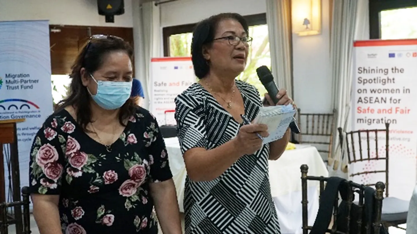 Sally Barrios talks with another female participant during a migrant reintegration workshop.