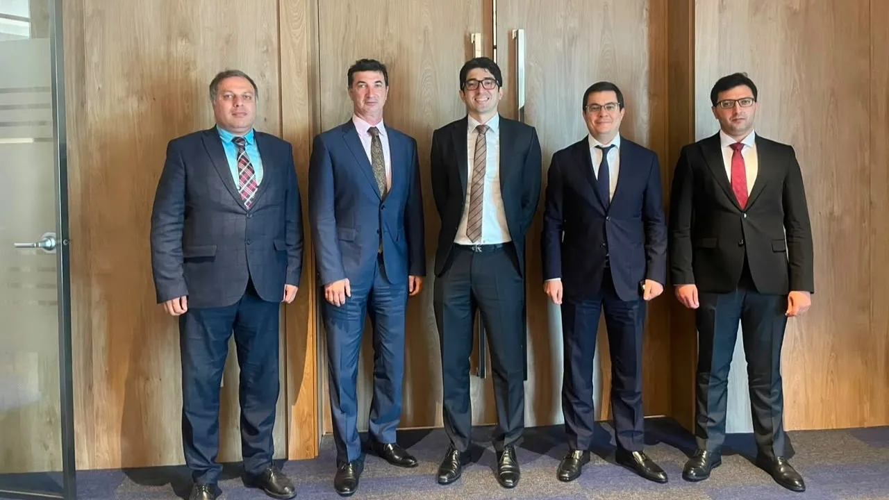 Five men standing side by side