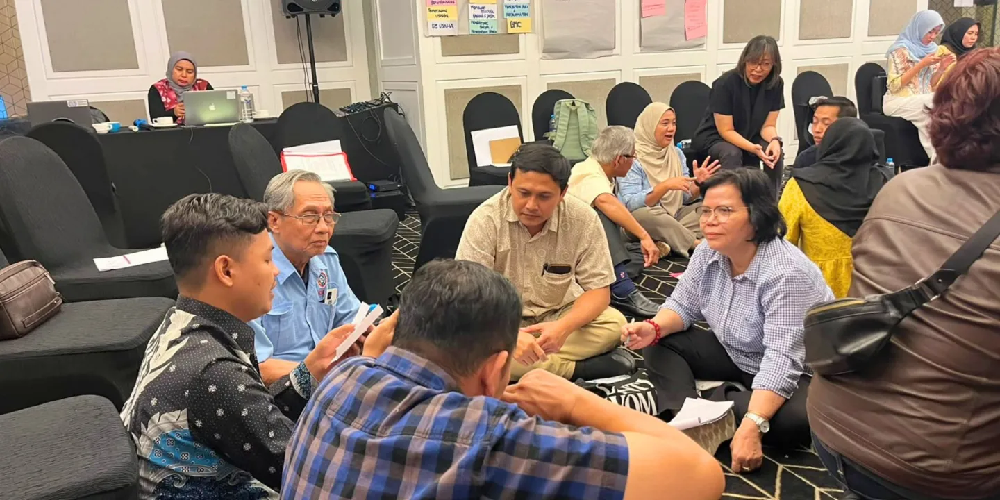 A group of people sitting on the floor 