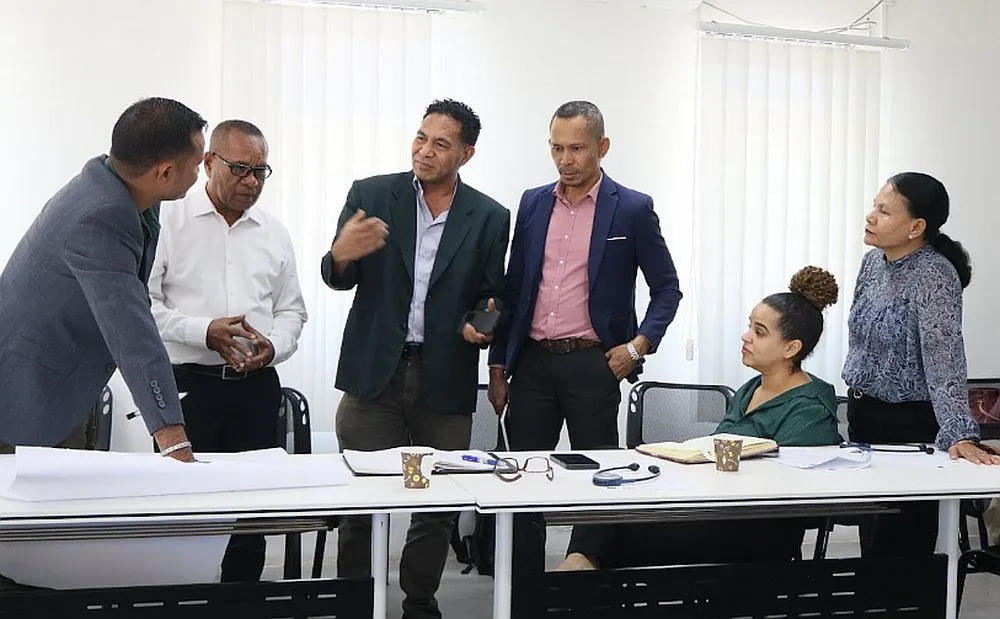 Six people standing and discussing
