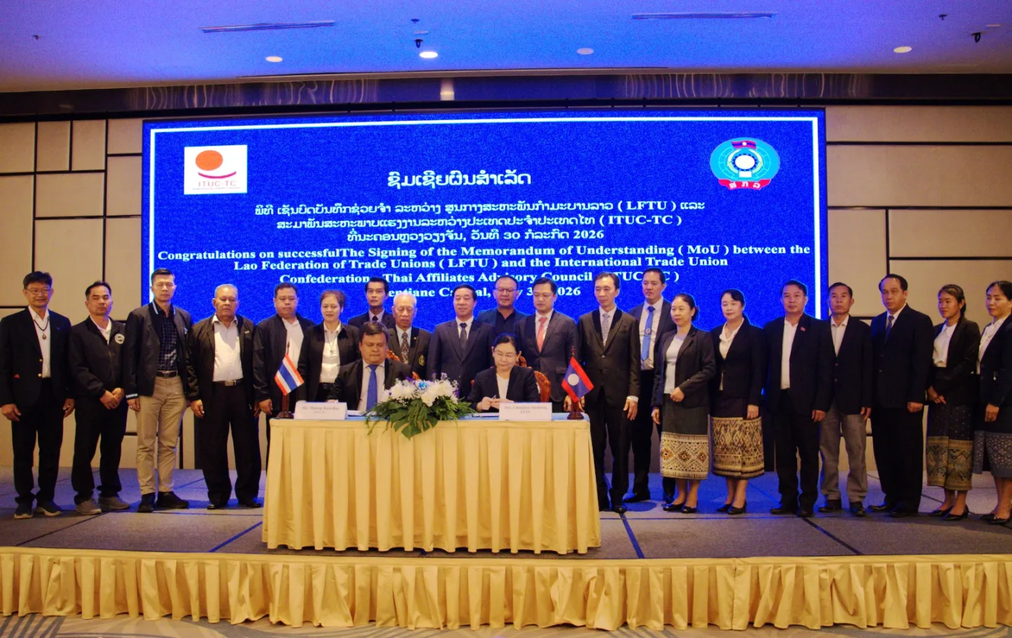 Representatives of the Lao Federation of Trade Unions (LFTU) and the International Trade Union Confederation–Thailand Council (ITUC-TC) sign a memorandum of understanding.