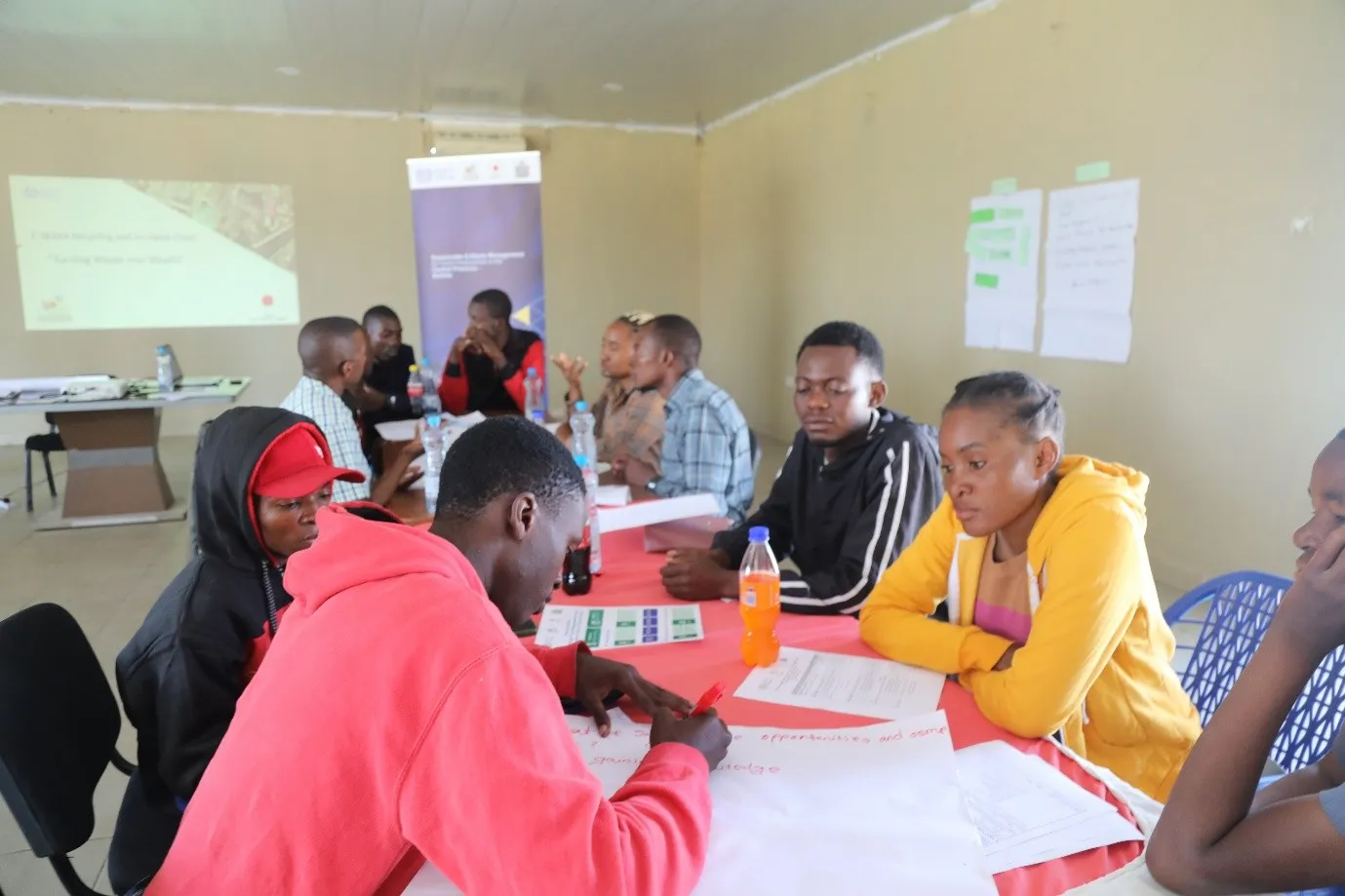 Young women and men around the table during project workshop
