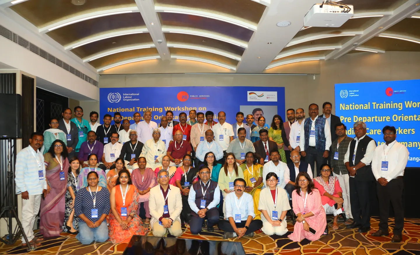 A large group of participants pose for a group photo.