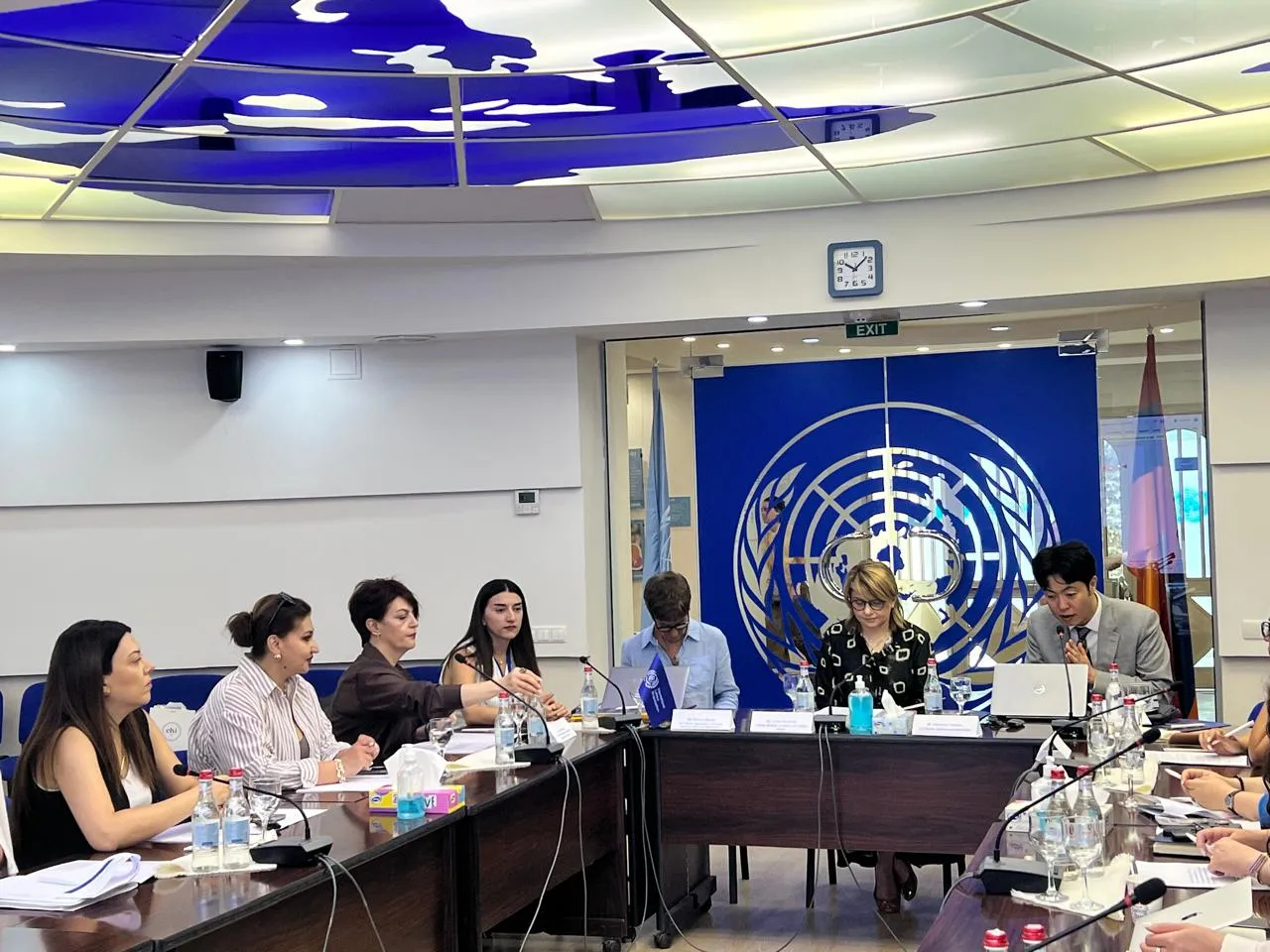 Participants seated around a conference table during a meeting