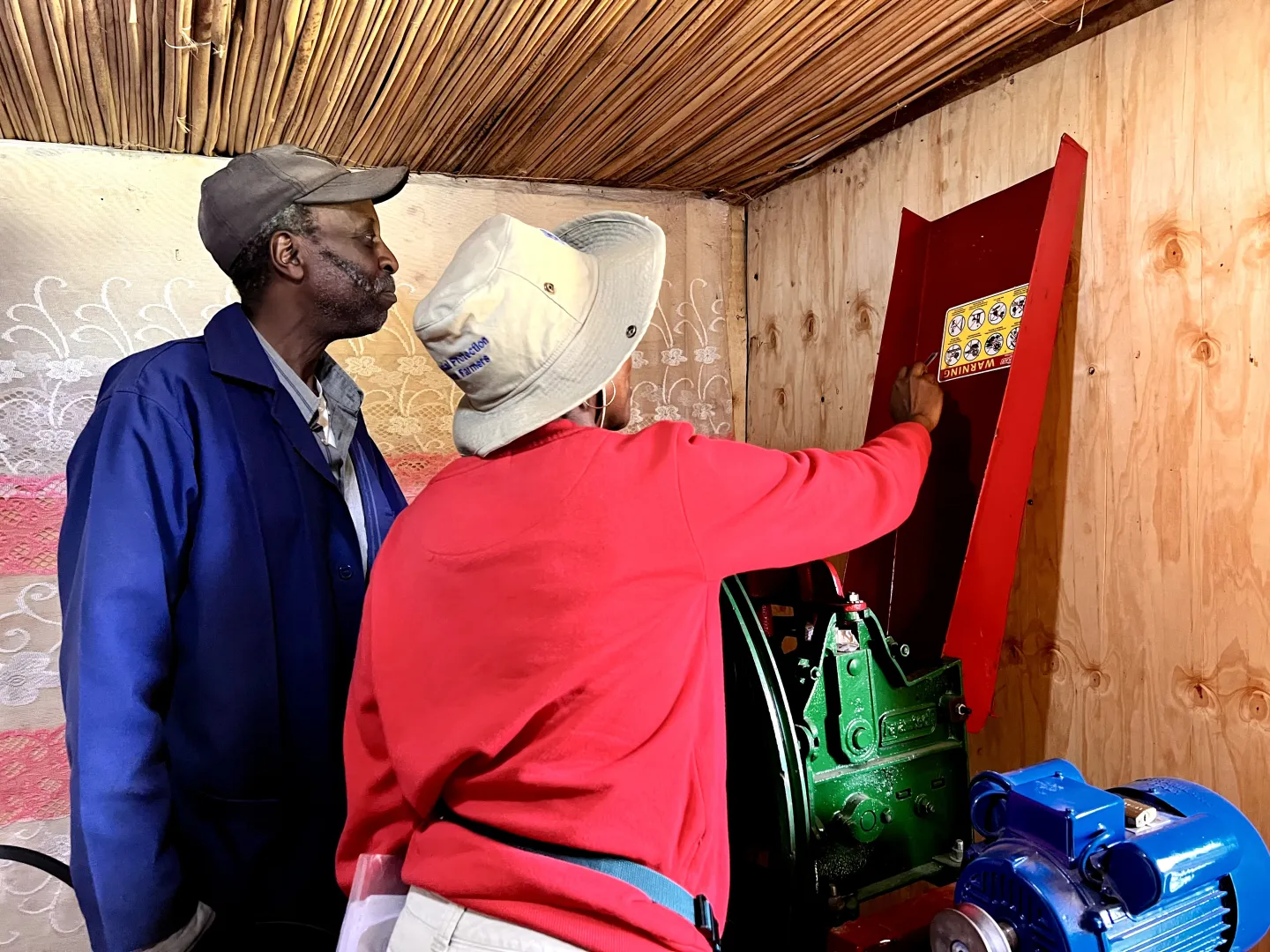 A farmer being shown key machine operating instructions
